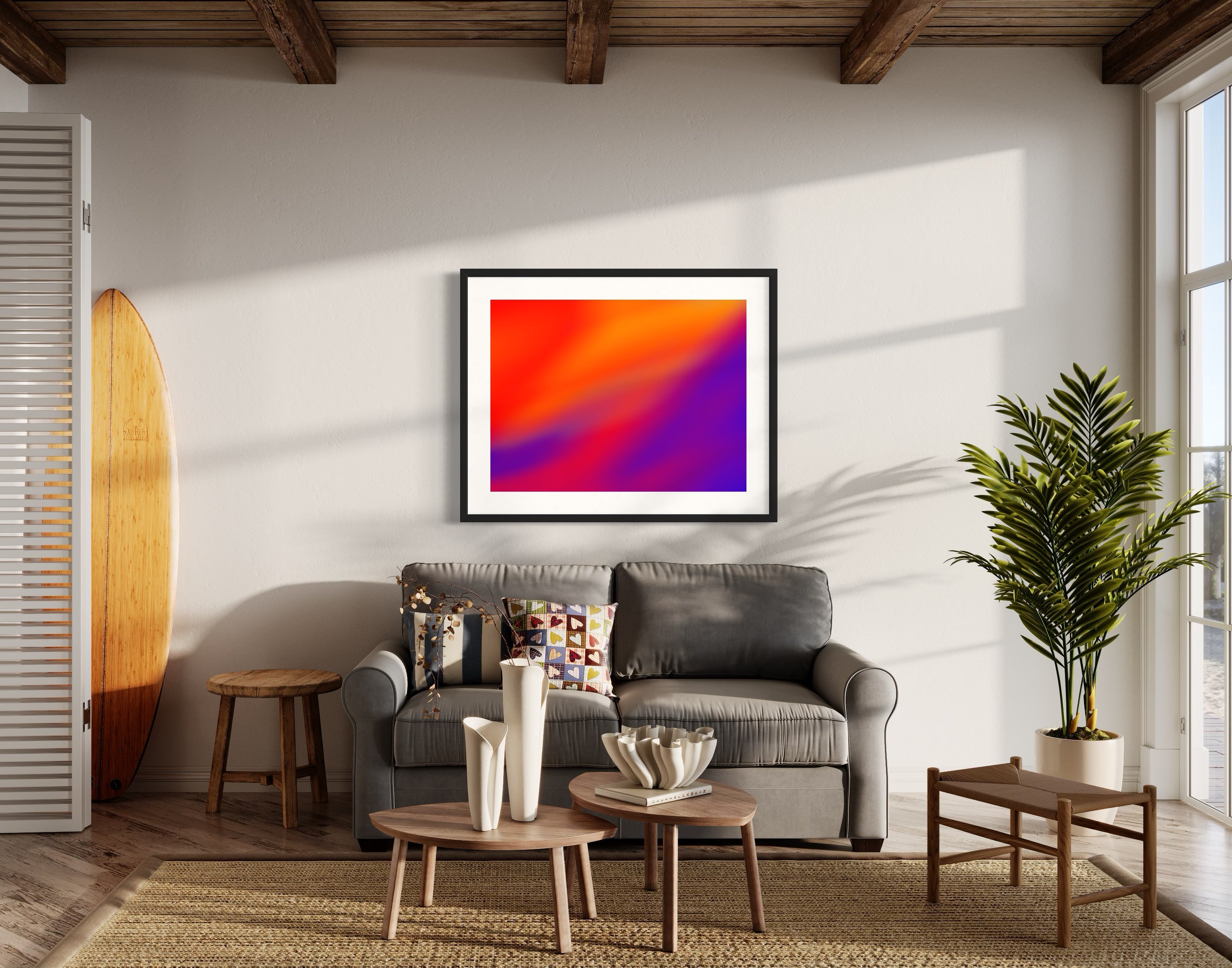photo of abstract orange, yellow and purple in black frame with white matte on white wall in beach house living room