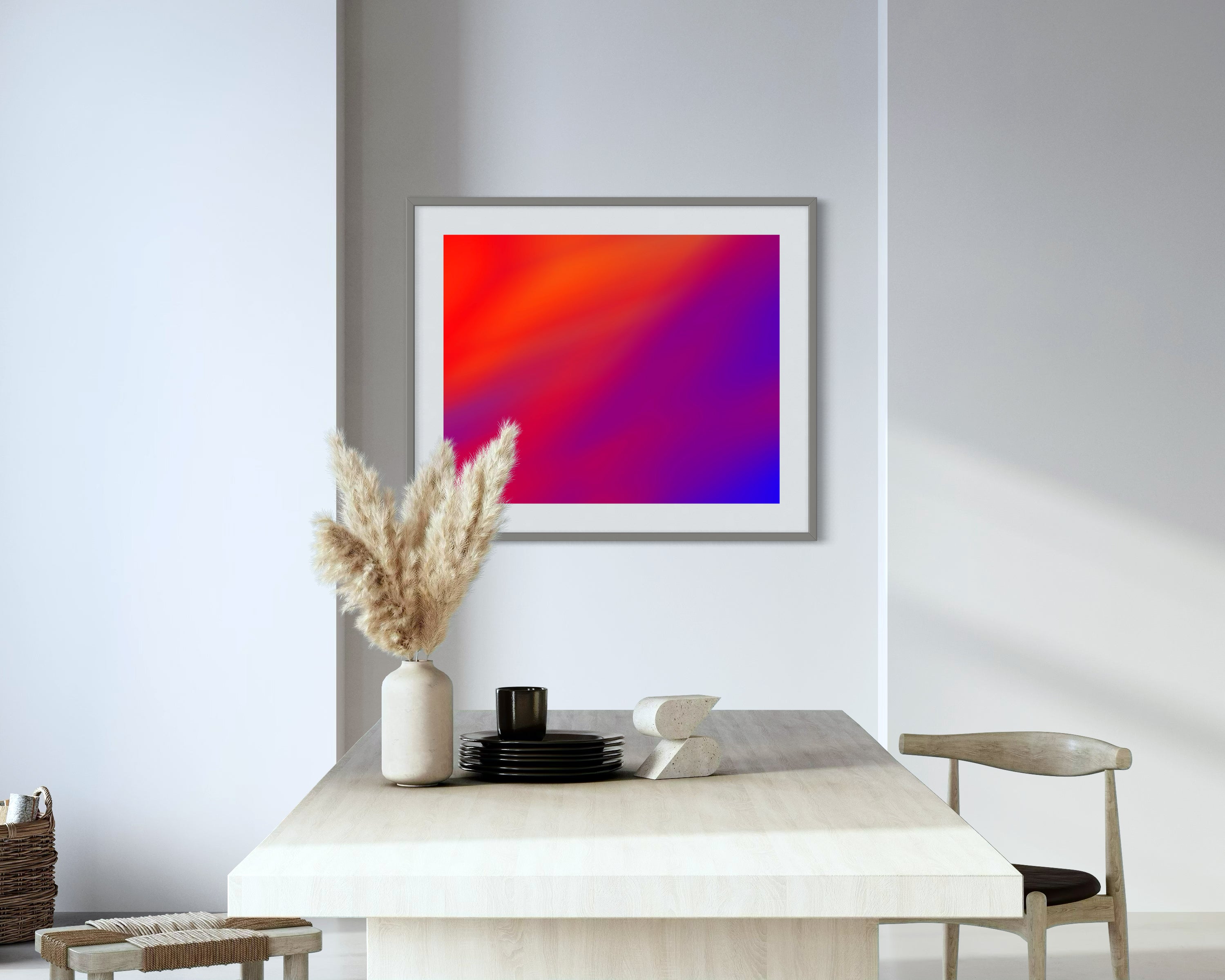 photo of abstract orange, yellow and purple in gray frame with off white matte on off white wall in very minimalist dining area