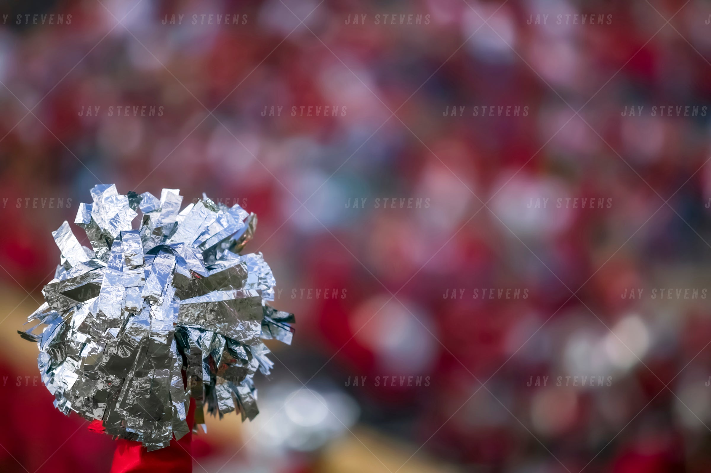 Close-up of a silver pom-pom against a blurred background