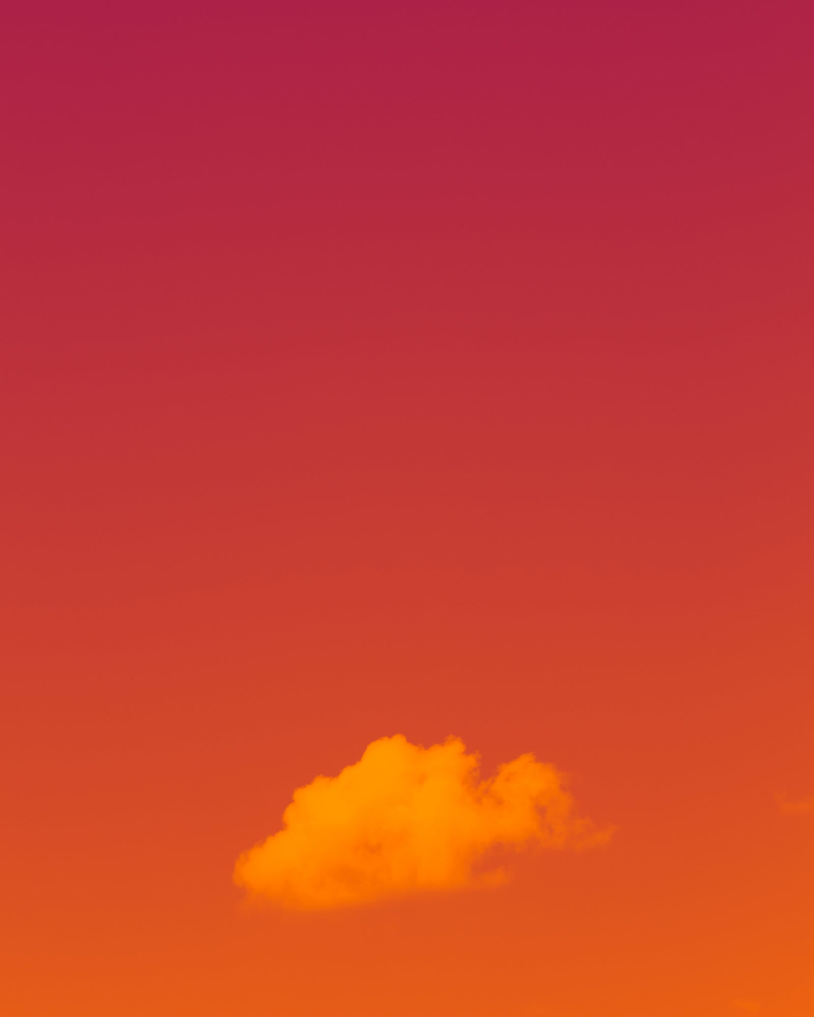 photo of cloud at bottom center of frame, simple warm pastel tones