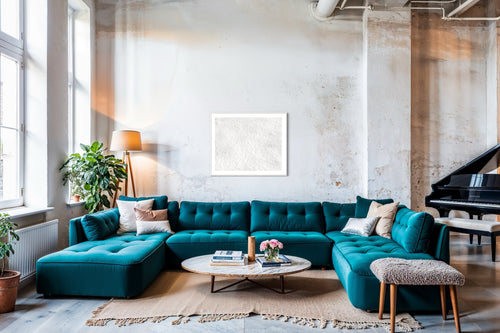 Close up photo of fresh white clean snow in white frame with white matte concrete wall in loft with very large teal couch and baby grand piano.