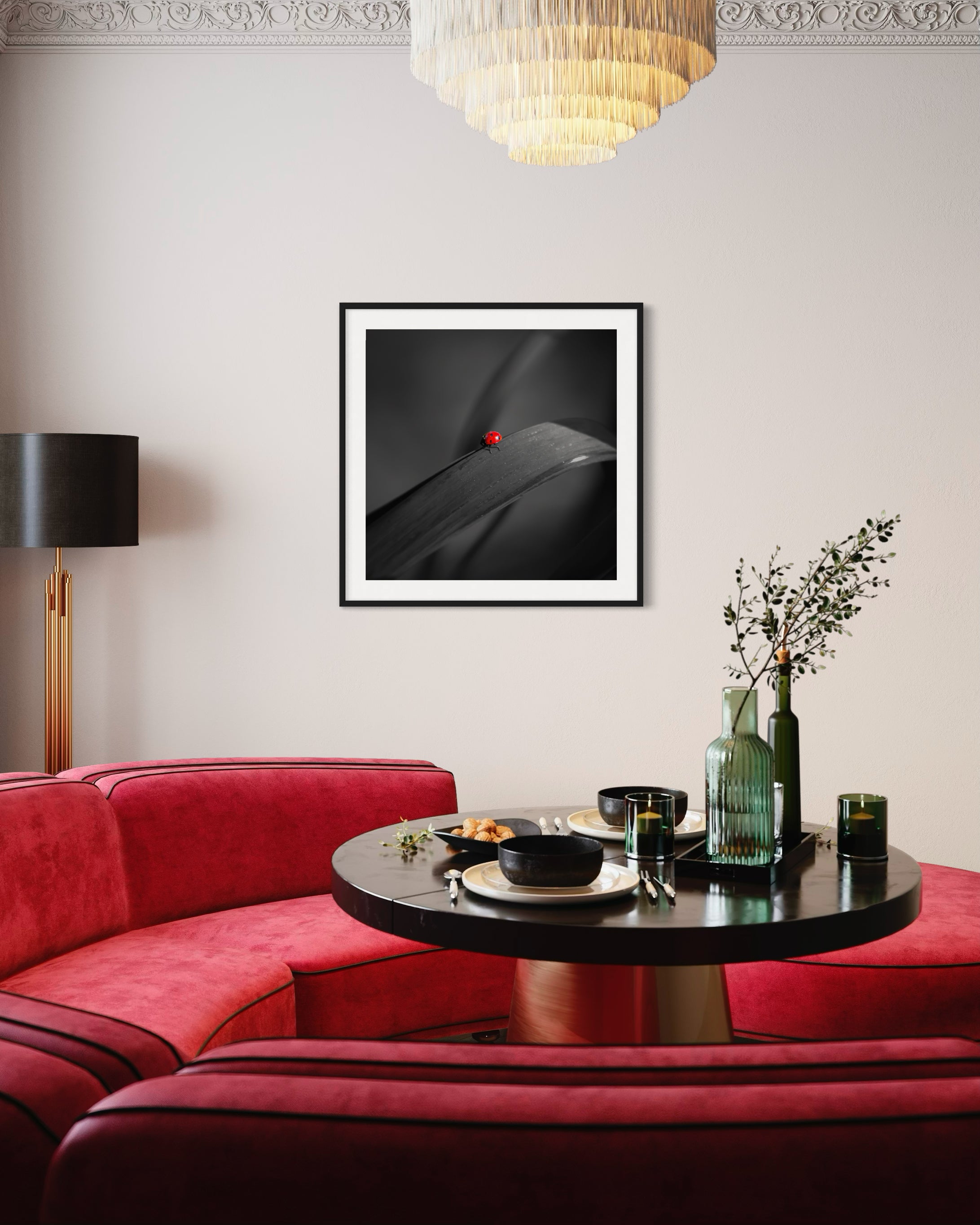 photo of Ladybug in middle of square image, everything except the Ladybug is black and white in black frame on light tan wall in modern residential breakfast room