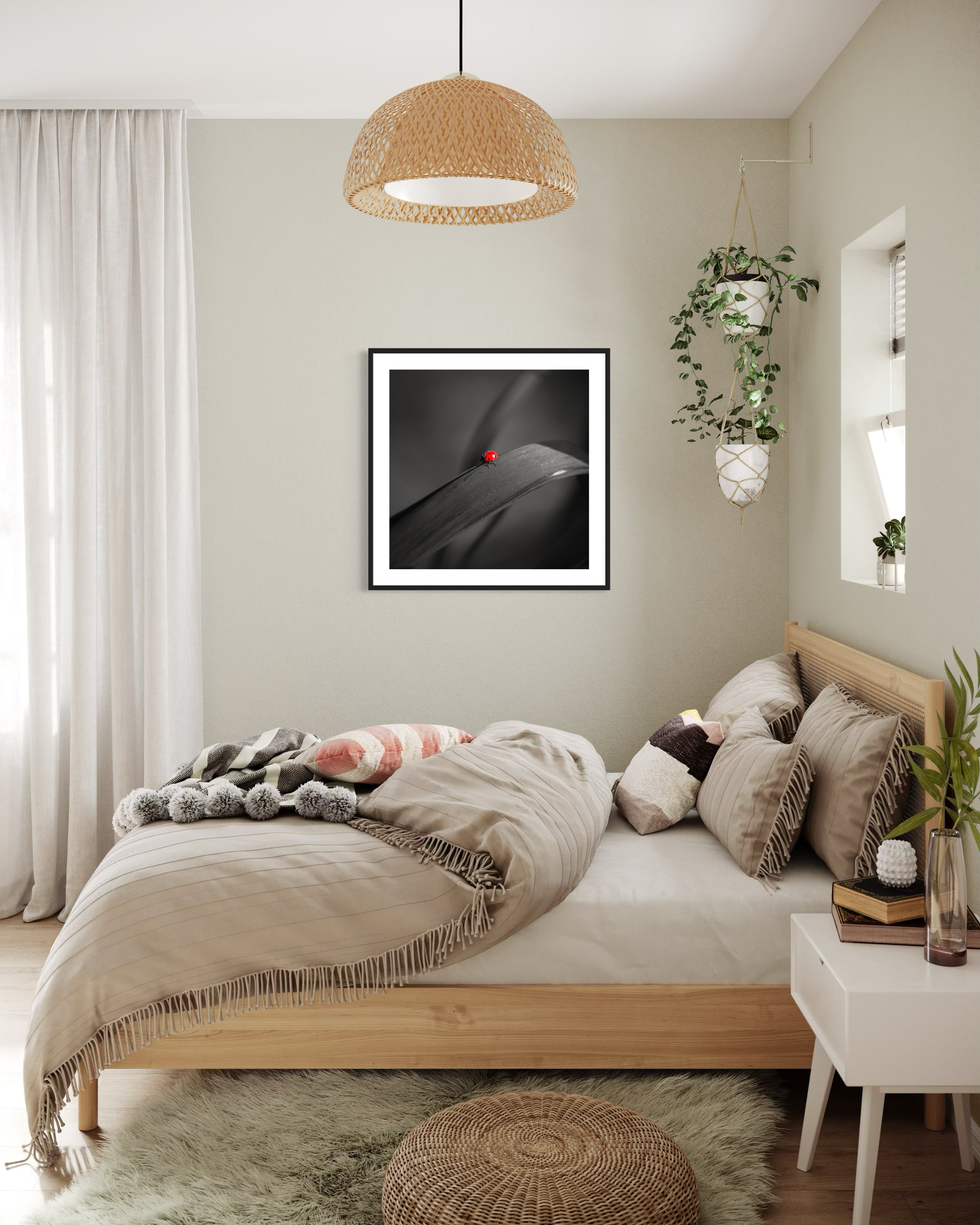 photo of Ladybug in middle of square image, everything except the Ladybug is black and white in black frame on light tan wall in Scandinavian style bedroom