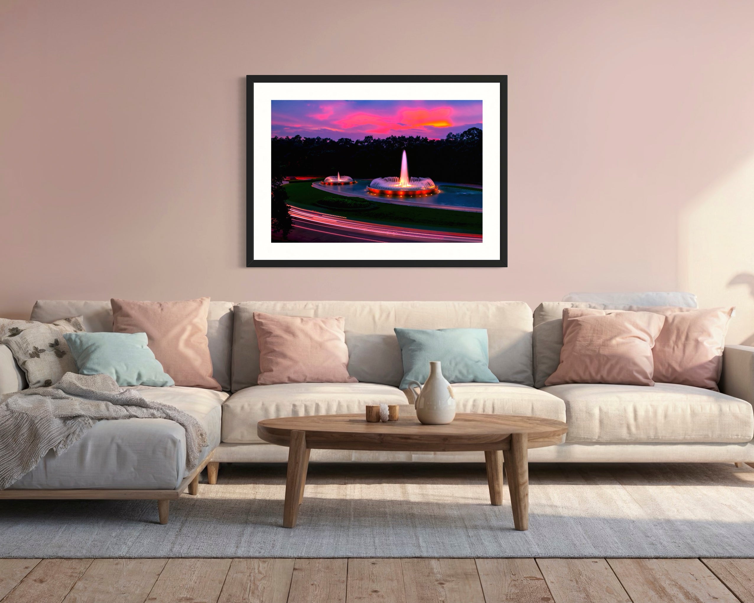 photo of Mecom Fountain in Houston shot at sunset with blurred car lights at the bottom on pastel pink wall above couch