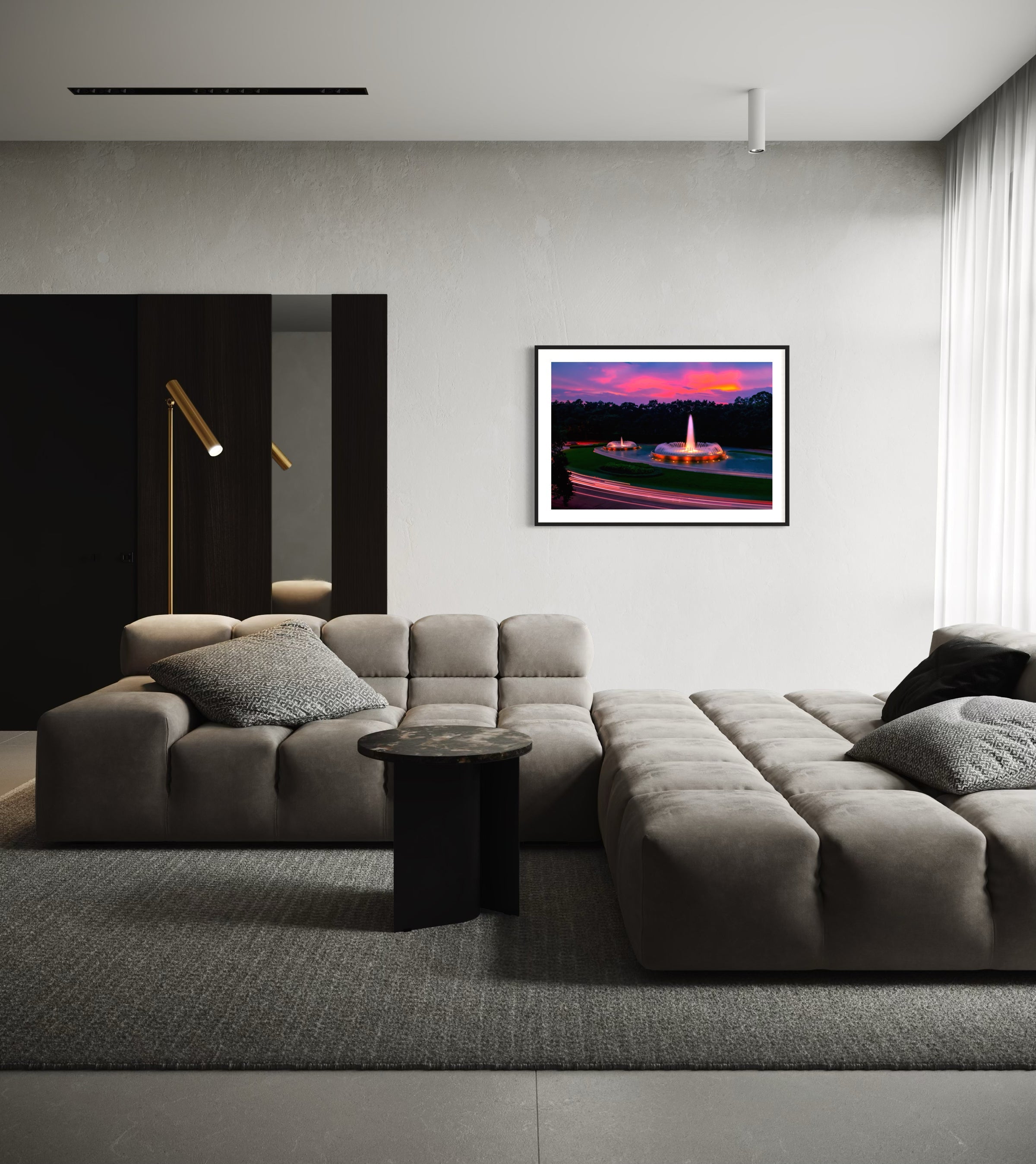 photo of Mecom Fountain in Houston shot at sunset with blurred car lights at the bottom in black frame with white matte on white wall in modern living room with gray tones including large gray sectional couch