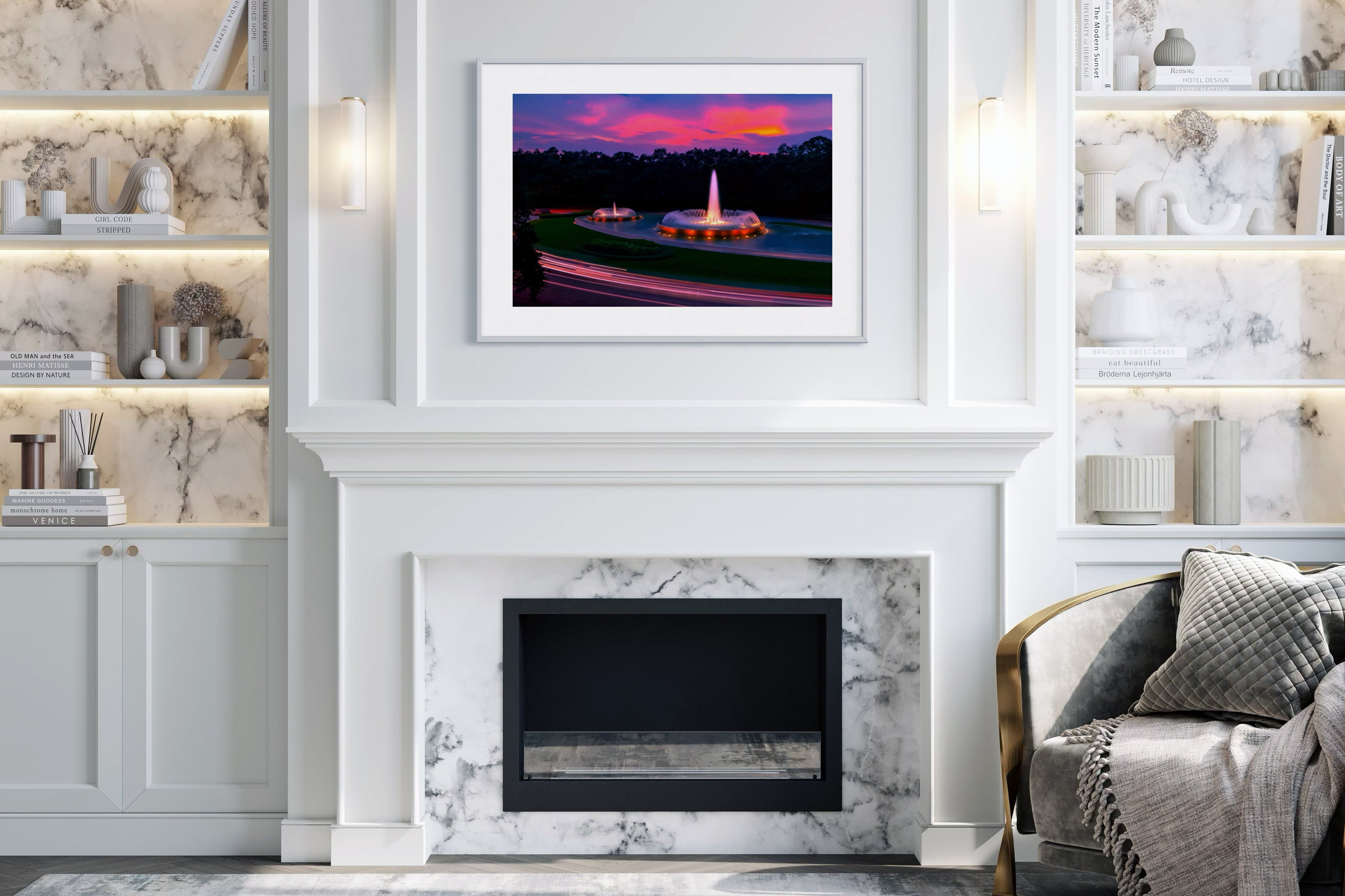 photo of Mecom Fountain in Houston shot at sunset with blurred car lights at the bottom in white frame with white matte on wall above fireplace in modern living room with mostly white colors 