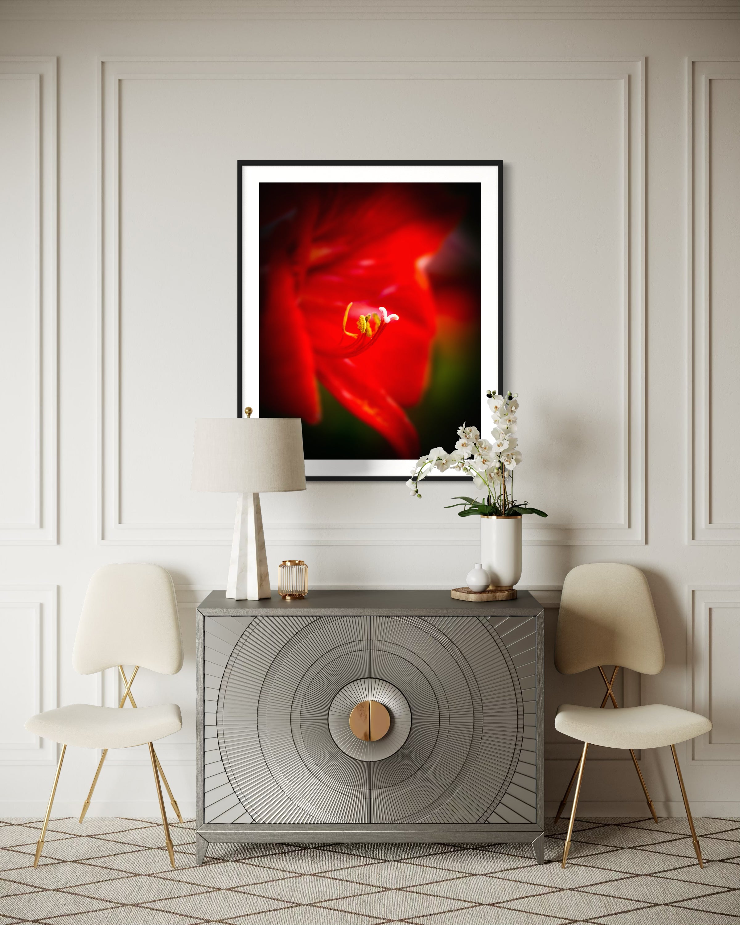 macro photo of red flower, selective focus in black frame on light brown wall above modern small gray table with small chairs on each side