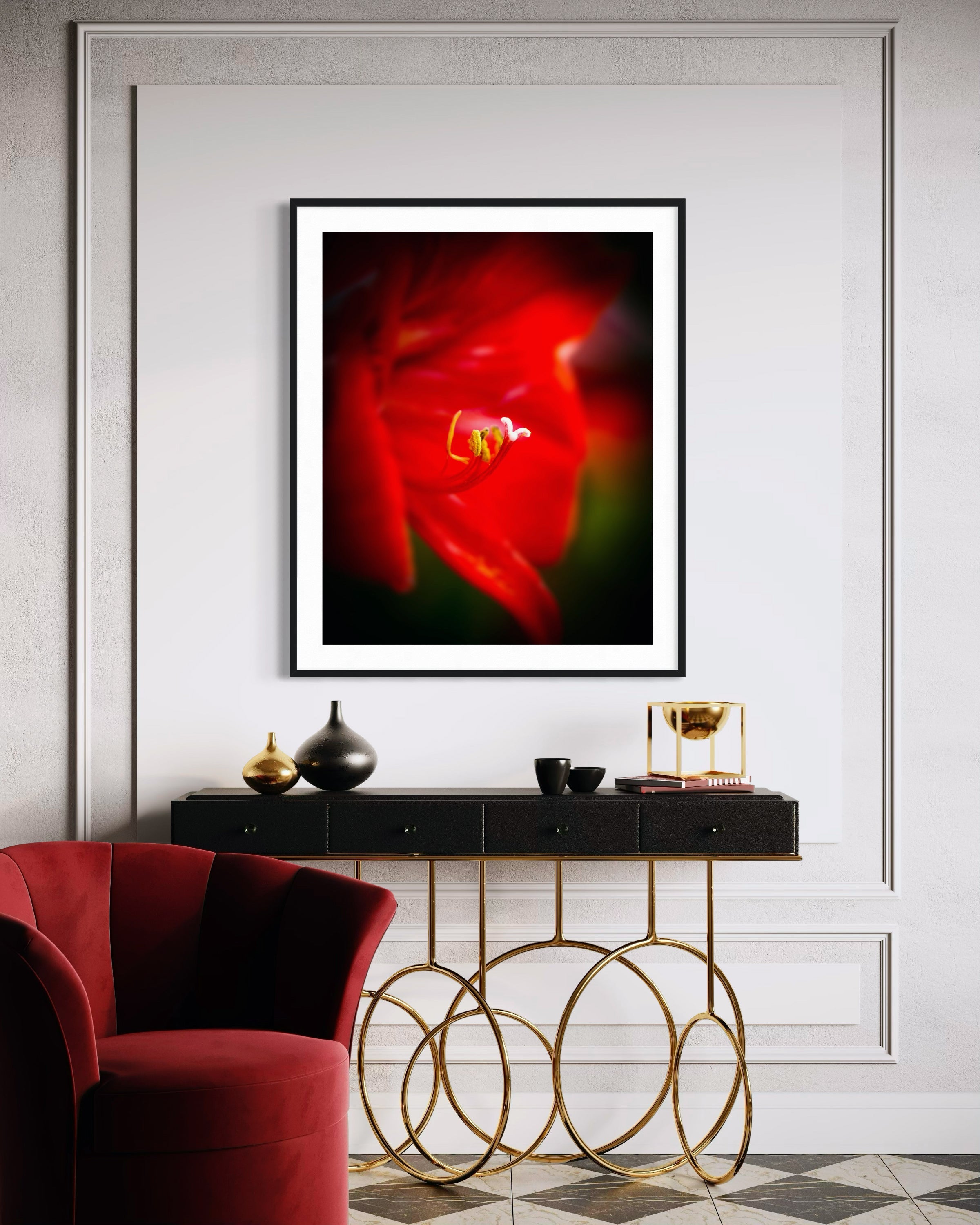 Framed abstract artwork with a red and black color scheme in a modern interior setting.