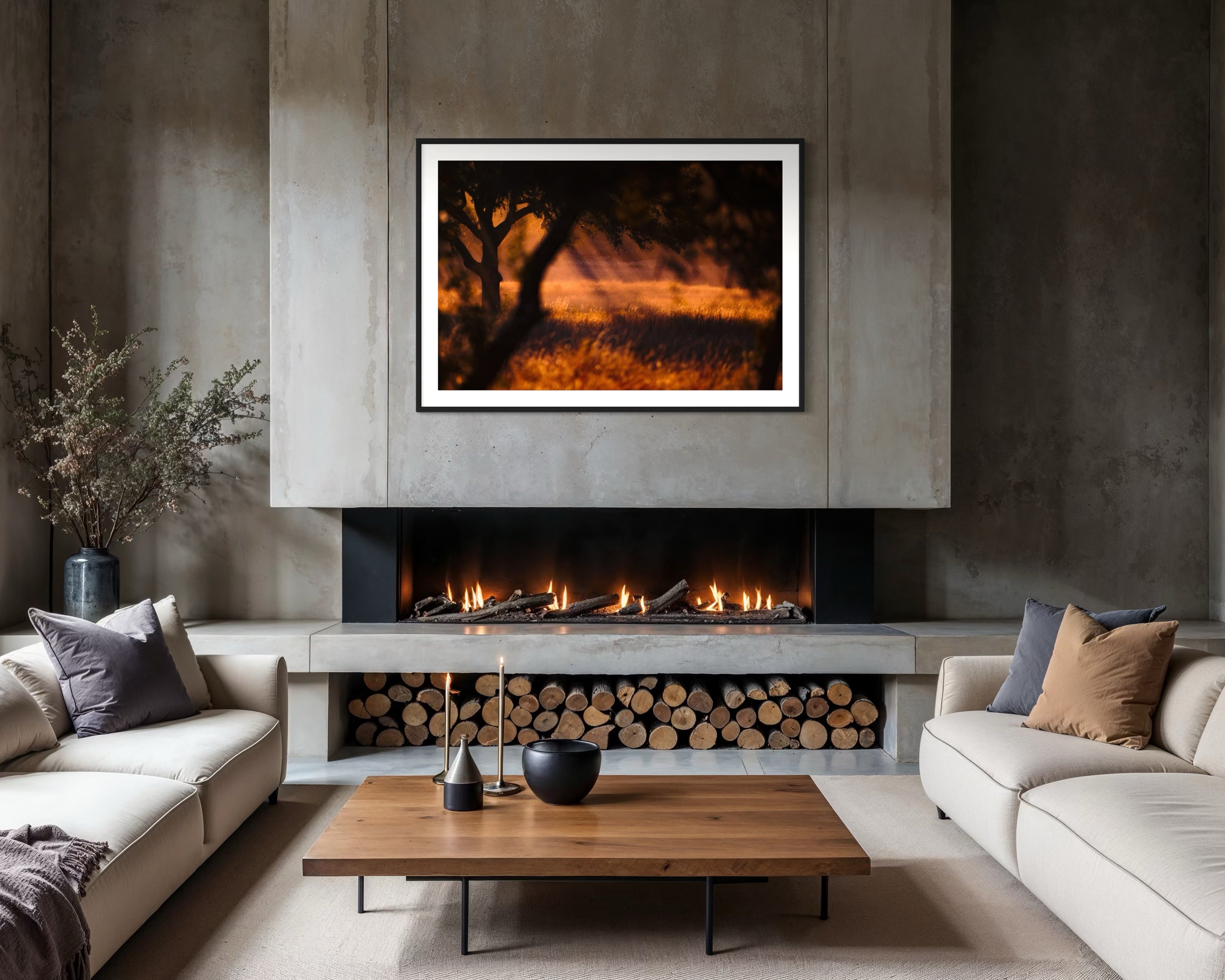 Modern living room with a fireplace, framed artwork, and neutral decor.
