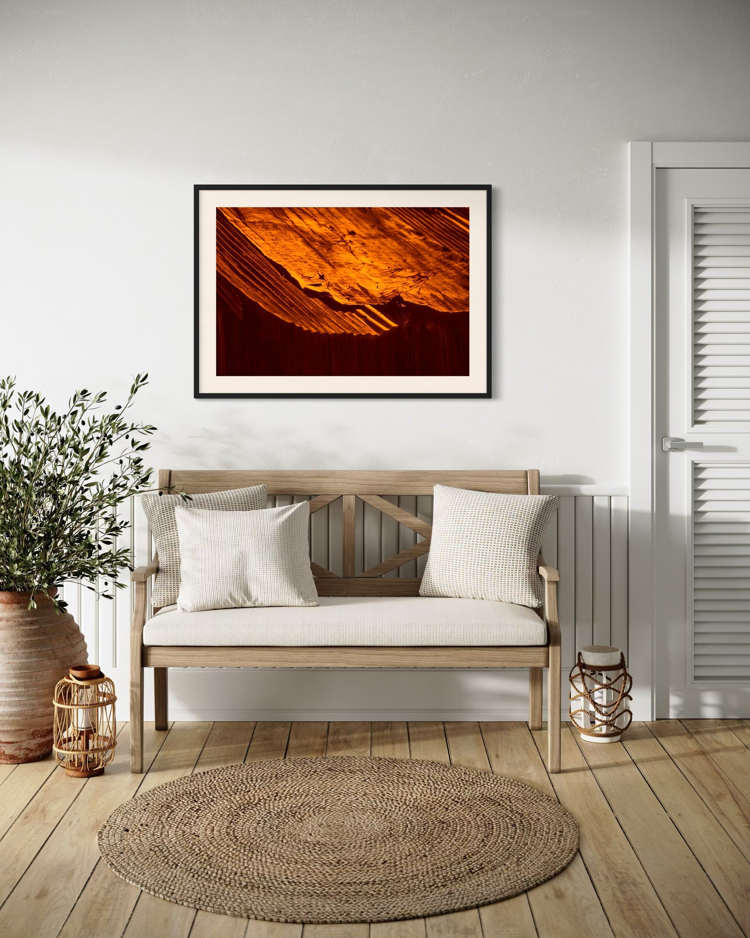 rusty old metal roof on old barn with warm tones photo in black frame with off white matte on white wall in country style residential seating area with wooden bench and light hardwood floors