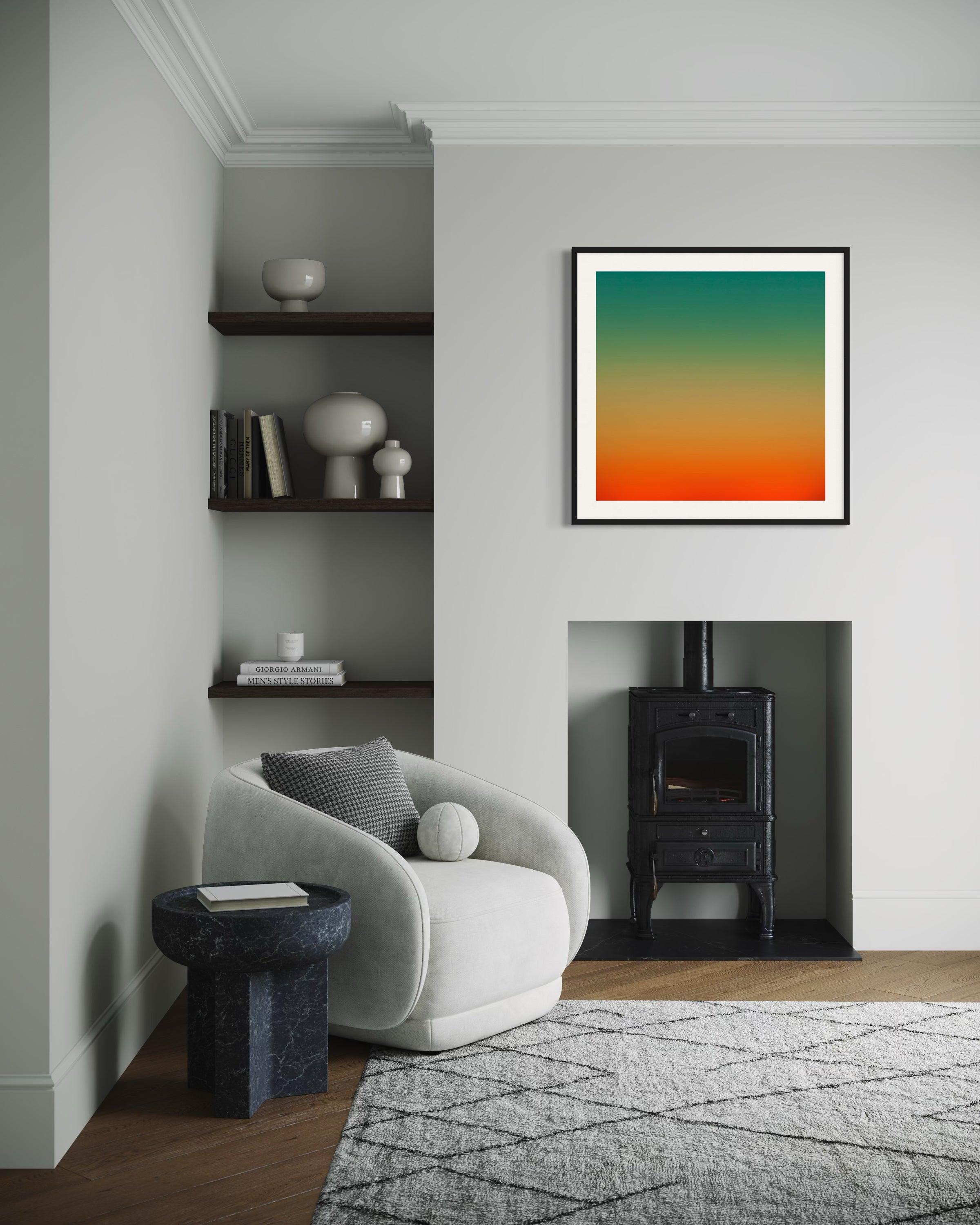 Cozy living room with a white armchair, a black side table, and a geometric rug. A colorful gradient artwork hangs above a black wood stove. Neutral tones create a calm atmosphere.