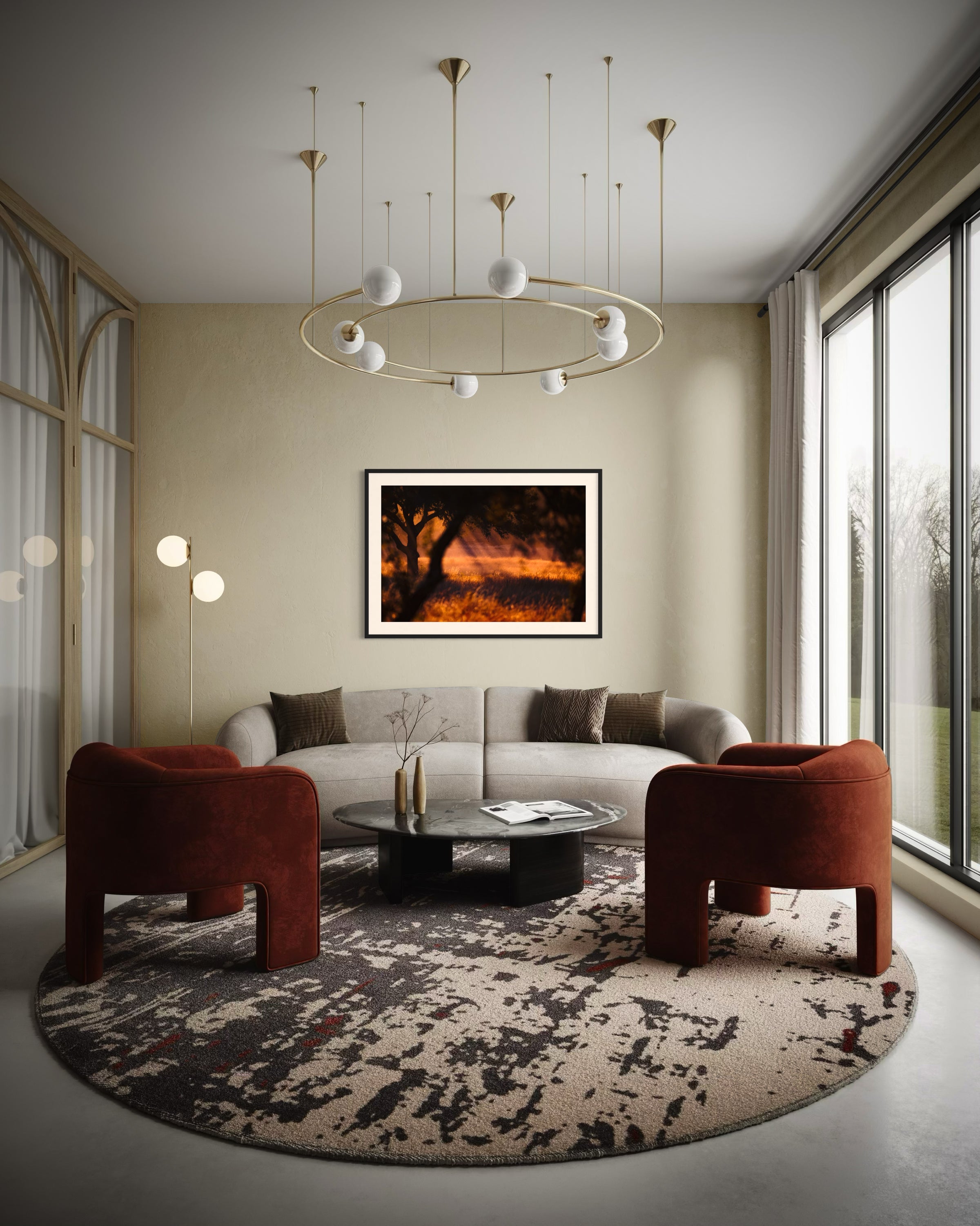 photo of rays of sunlight through the trees in black frame with white matte on tan wall in modern living room with funky light fixture, gray couch, two burgundy chairs and a round abstract rug