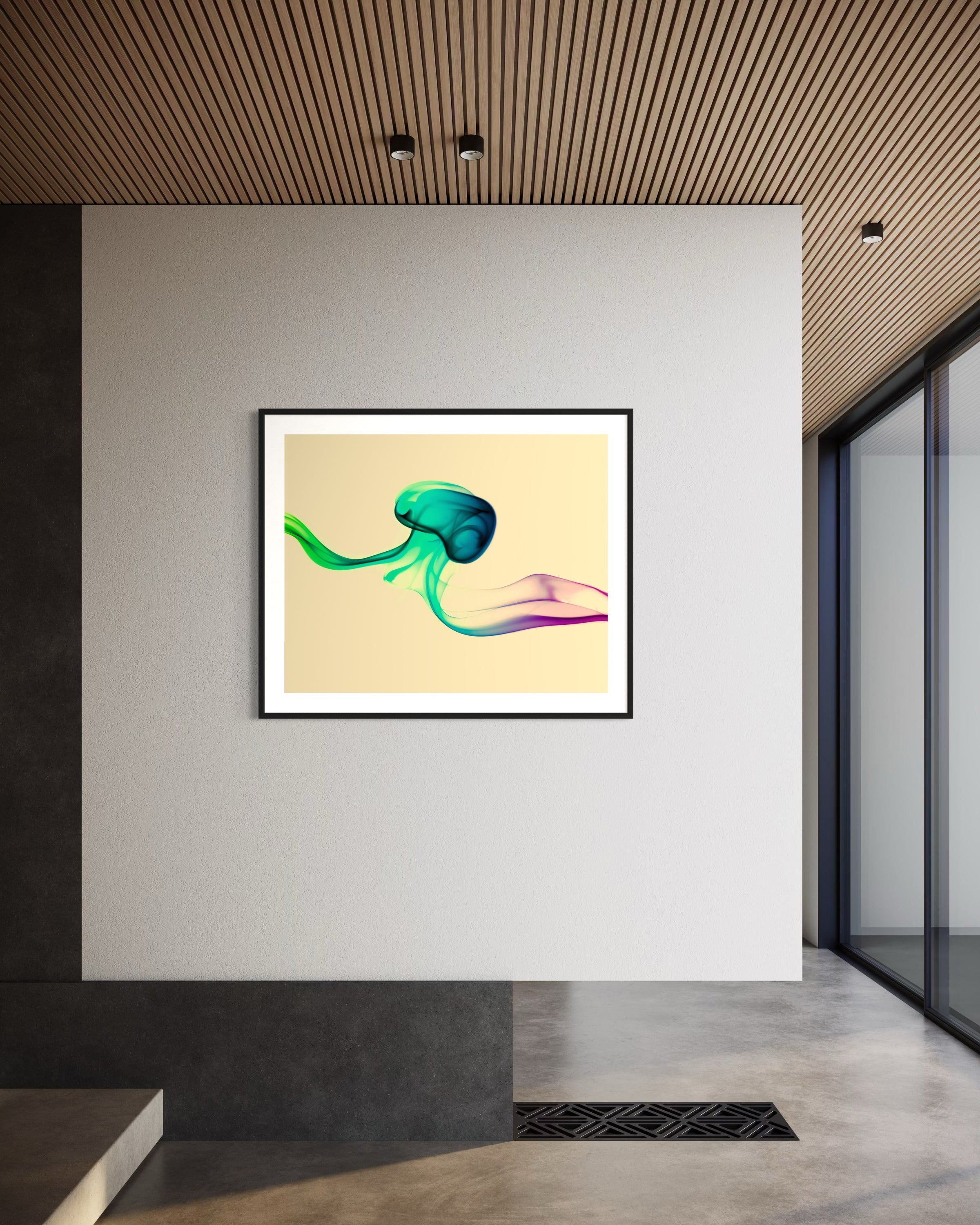 photo of abstract purple, green, blue, yellow wave at the bottom on orange overall in black frame with white matte on white wall in minimalist office space with concrete floors