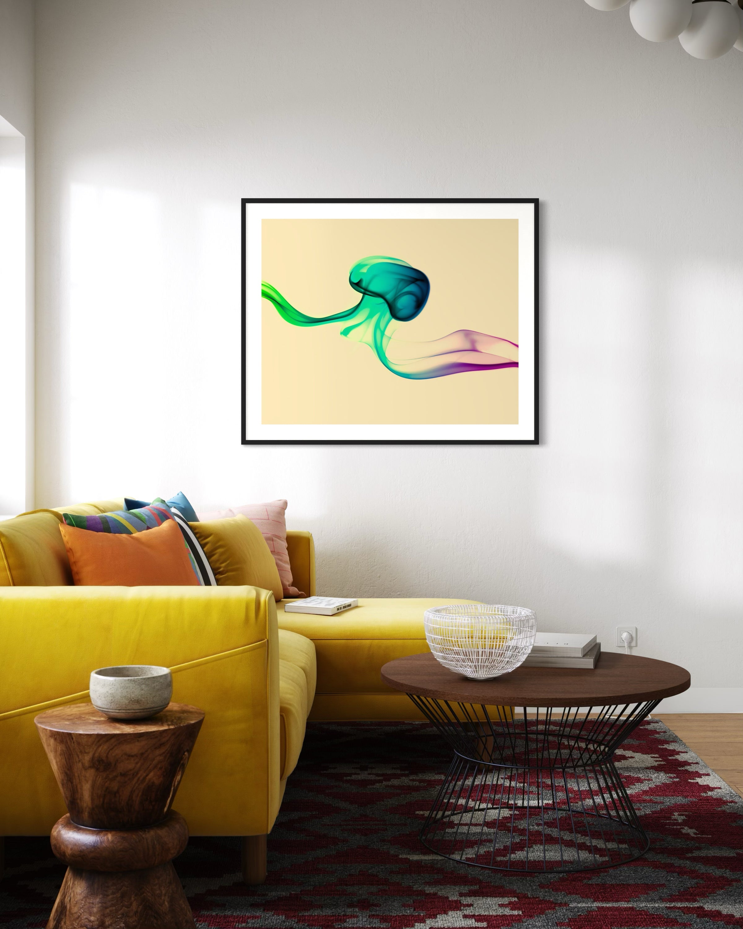 photo of abstract purple, green, blue, yellow wave at the bottom on orange overall in black frame with white matte on white wall in modern living room with bright yellow couch and round coffee table with wooden top and metal base