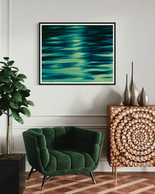 Modern interior with a green armchair, decorative cabinet, and abstract artwork on the wall.