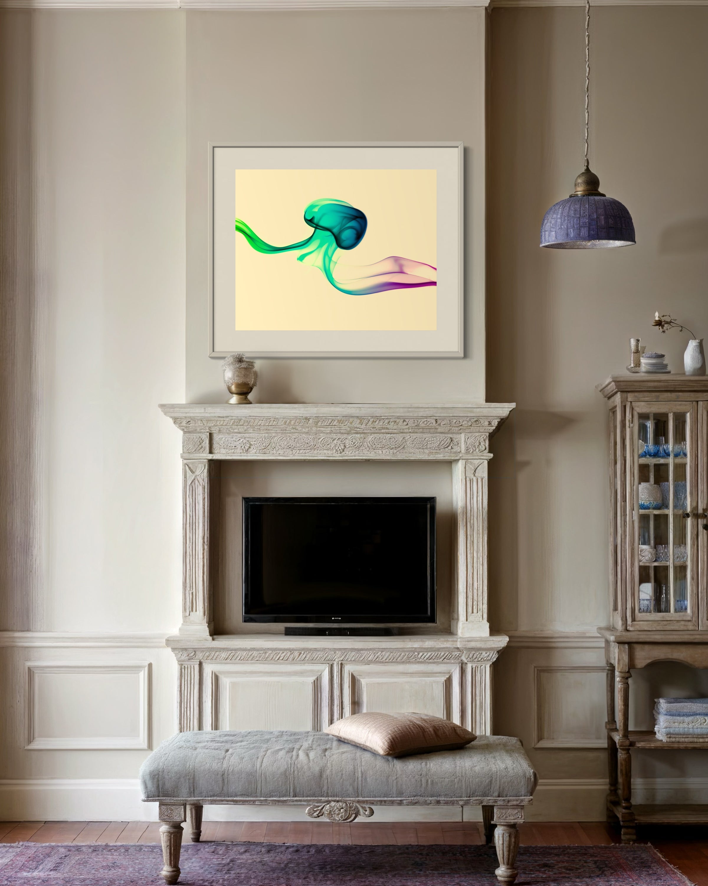 photo of abstract purple, green, blue, yellow wave at the bottom on orange overall in light tan frame on tan wall in earth toned ornate sitting room