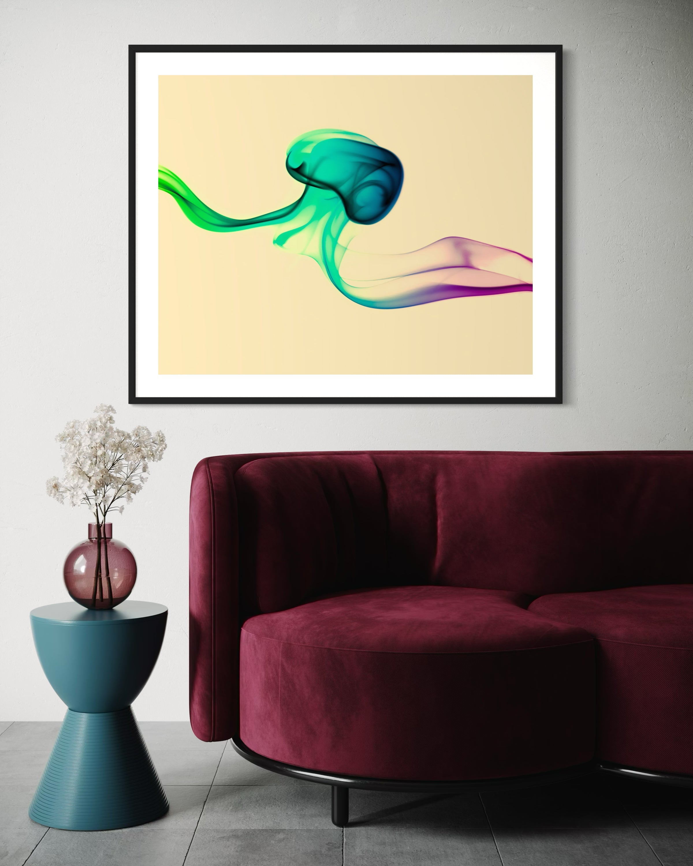 photo of abstract purple, green, blue, yellow wave at the bottom on orange overall in black frame with white matte on white wall above modern burgundy couch 