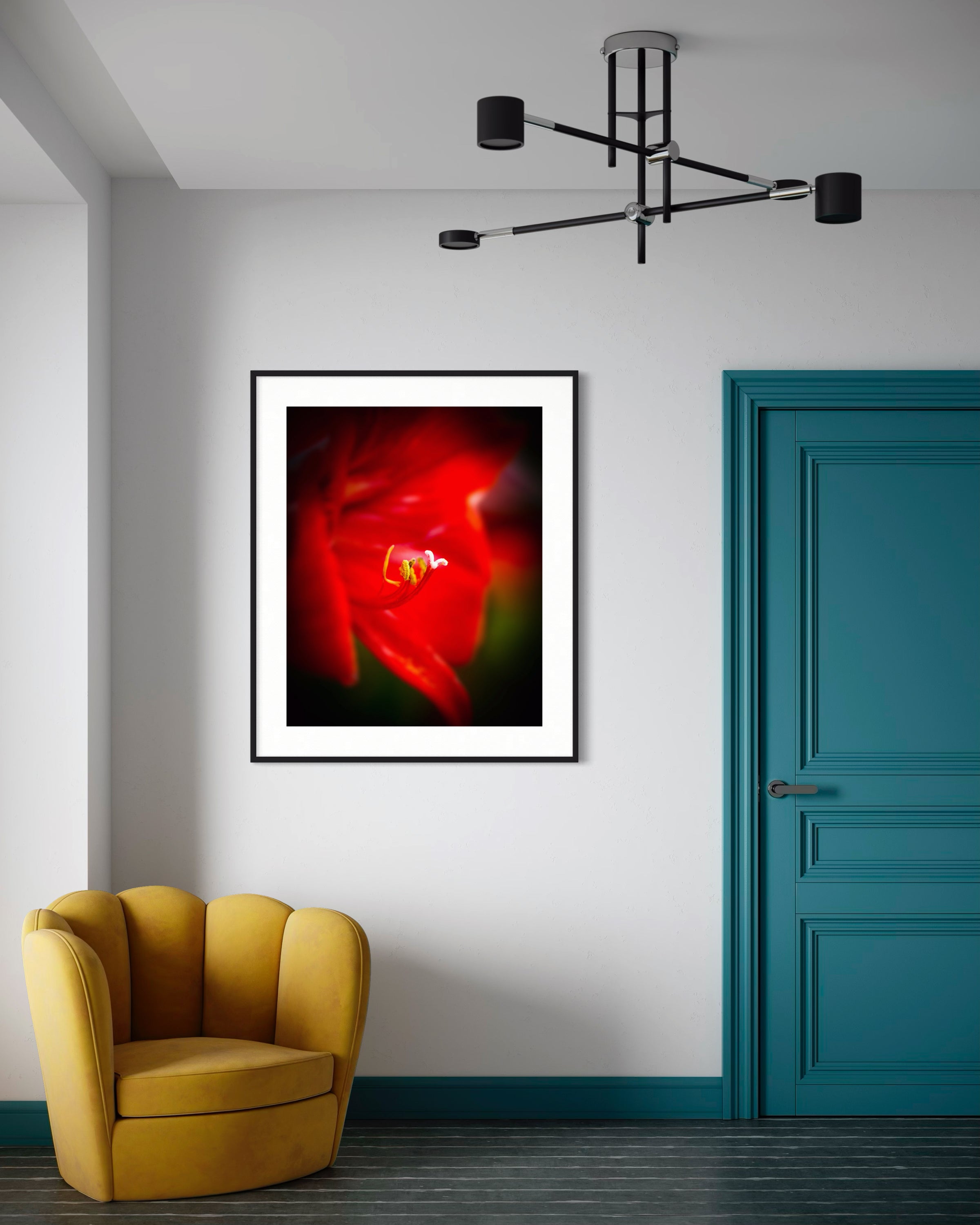 Framed abstract artwork with a red and black design on a wall above a yellow armchair.