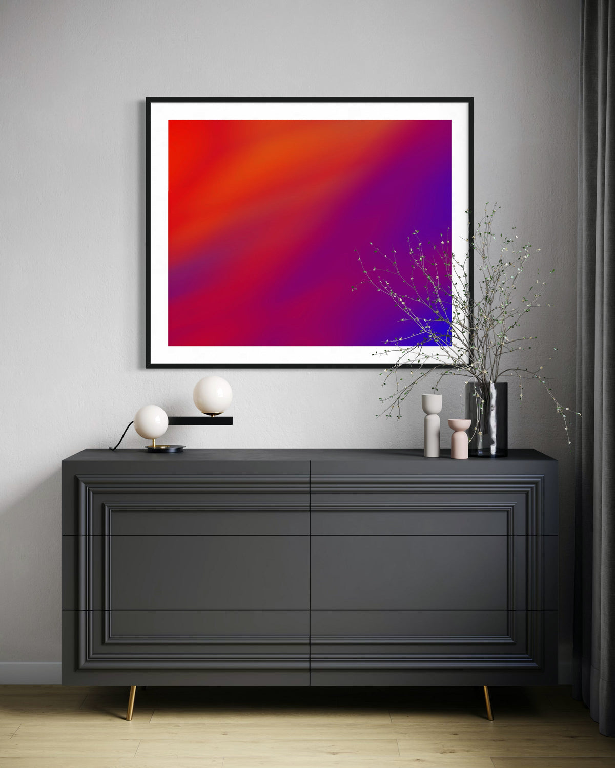 Modern interior with a black dresser, abstract art, and decorative items.