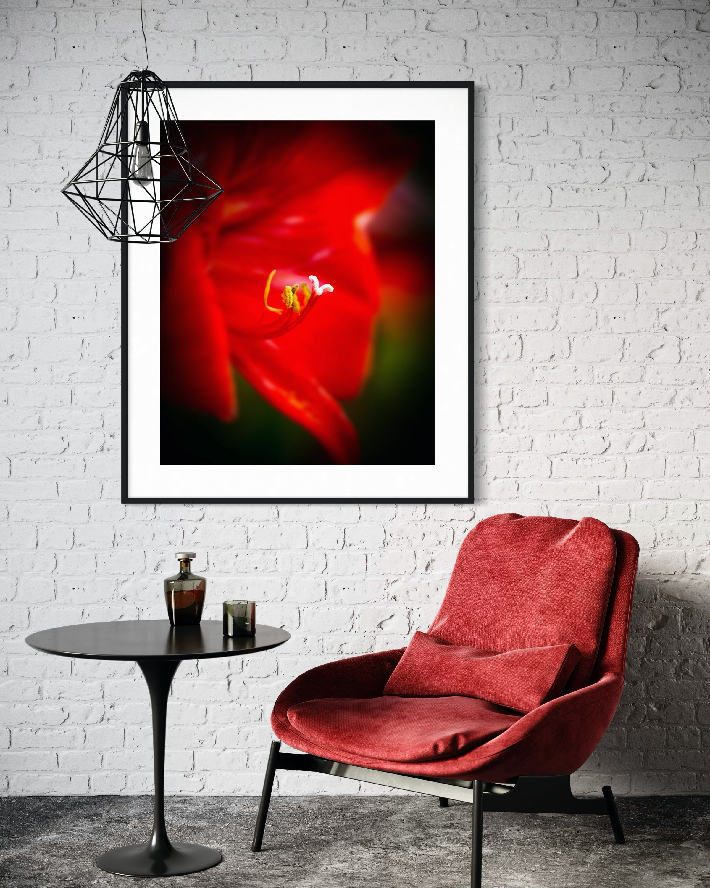Red chair in a room with a framed abstract artwork on the wall.