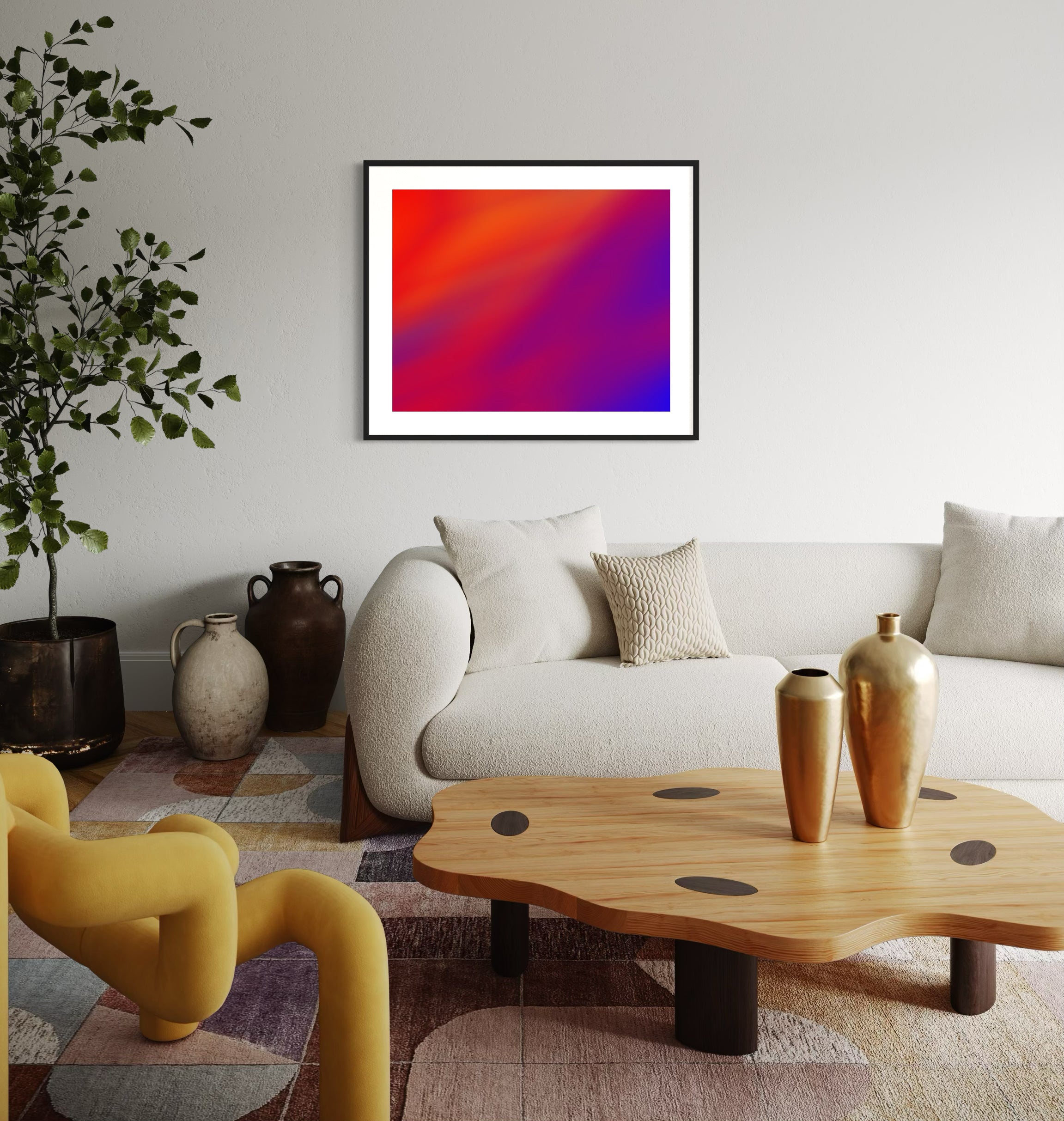 photo of abstract orange, yellow and purple in black frame with white matte on white wall in modern eclectic living room with white couch, funky shaped wooden coffee table and very modern yellow chair 