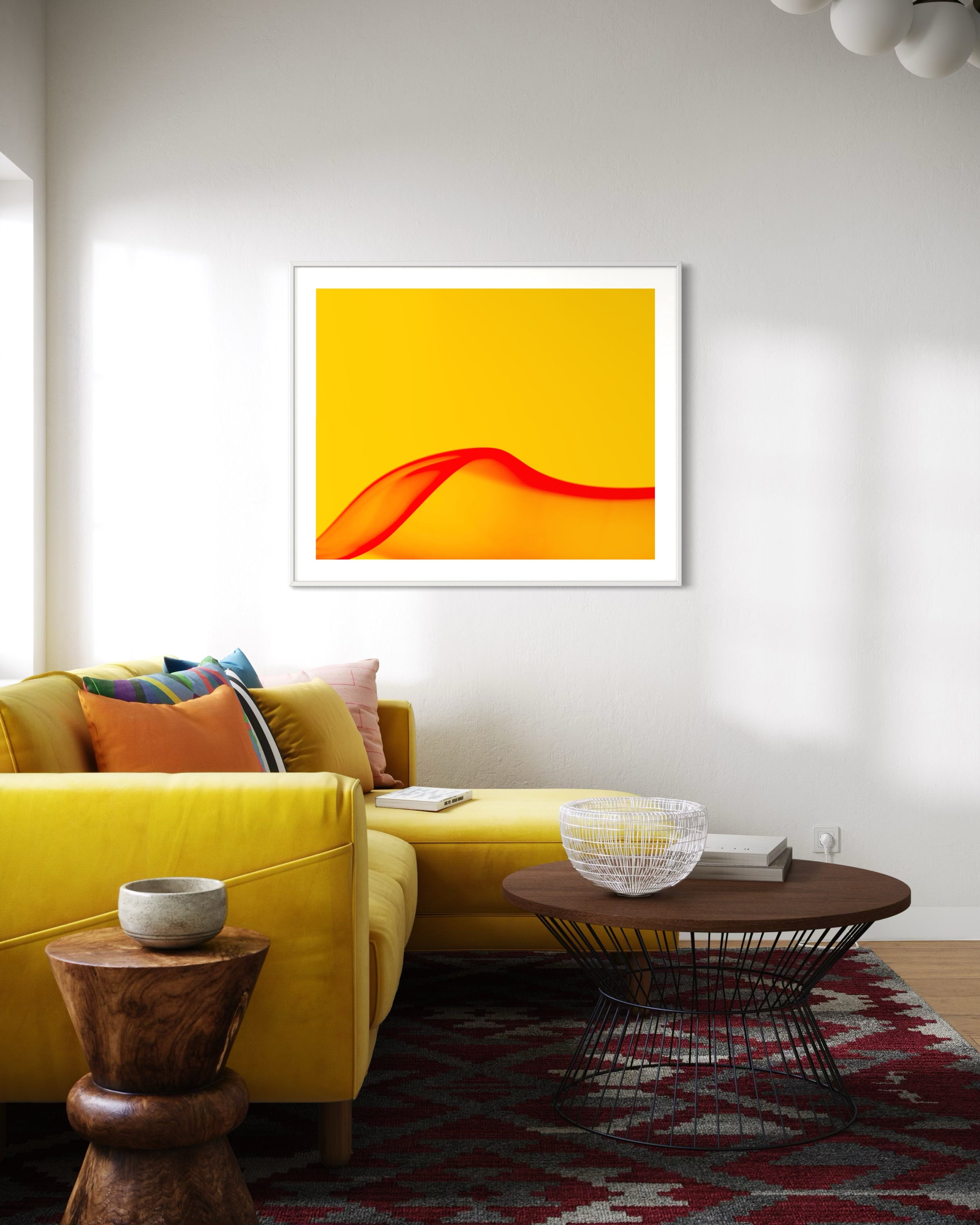 Living room with a yellow sofa, wooden coffee table, and abstract art on the wall.
