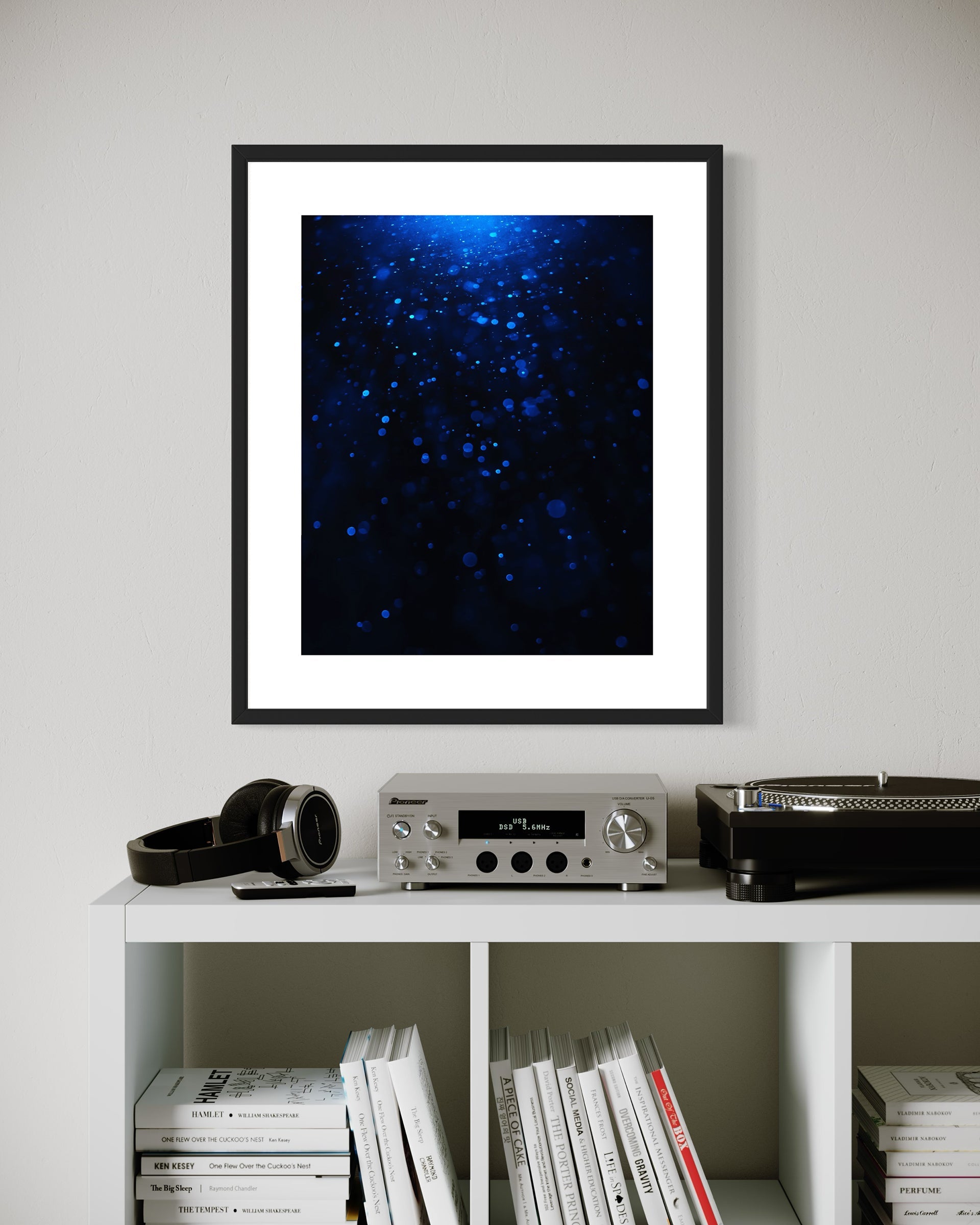 sci fi space looking photo as if close to the exterior of a space ship, blue tone, on off white wall above white table with component stereo